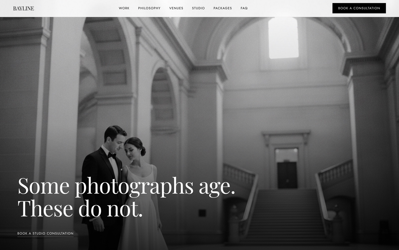 Bayline Studio website hero — a couple in wedding attire in a grand architectural interior, headline "Some photographs age. These do not."